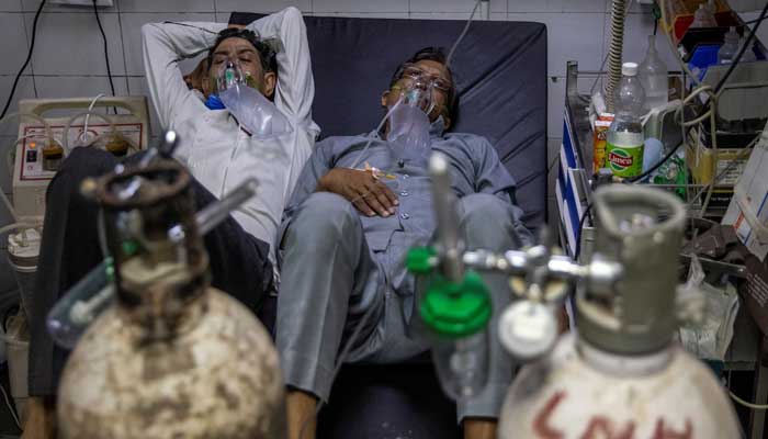 Two to a bed in Delhi hospital as India's COVID crisis spirals