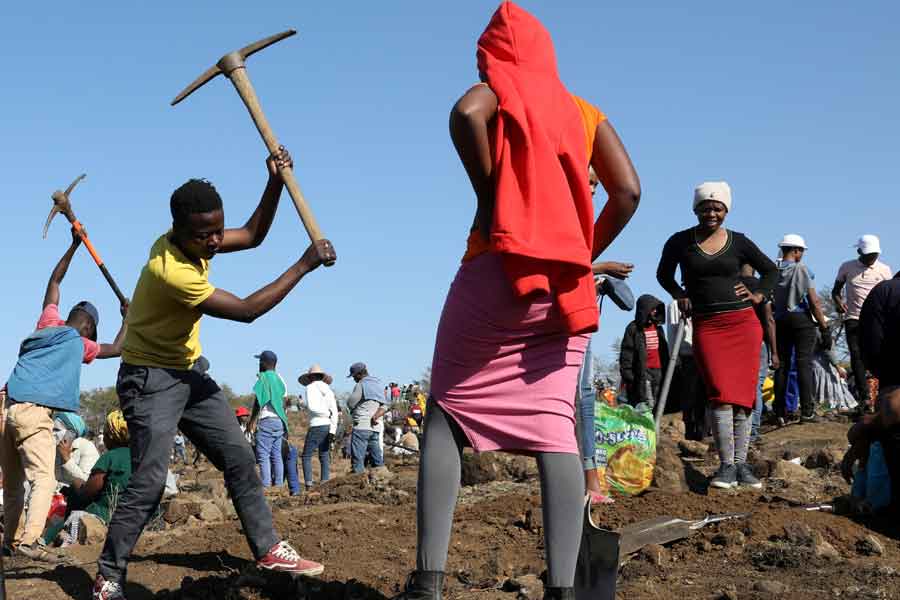 A person uses a pickaxe to dig as fortune seekers flock to the village after pictures and videos were shared on social media showing people celebrating after finding what they believe to be diamonds, in the village of KwaHlathi, outside Ladysmith, in KwaZulu-Natal province, South Africa, June 14, 2021. — Reueters/Siphiwe Sibeko