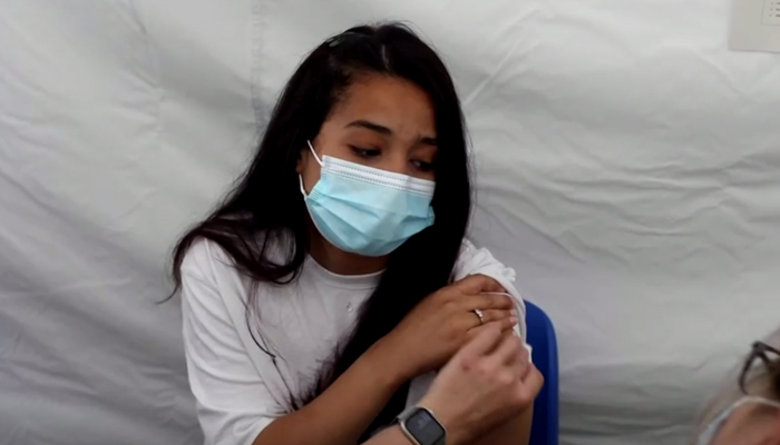 A girl getting vaccinated in France, on June 15, 2021. — Still from Reuters video