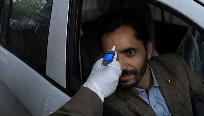 A Pakistani man gets his temperature checked. Photo: AFP