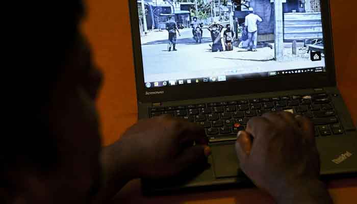 In this photo illustration taken on June 20, 2021 a user checks out a social media post on his laptop in Colombo after Sri Lankas military launched an investigation after social media posts showed soldiers humiliating minority Muslims by forcing them to kneel on the streets during a coronavirus lockdown. — AFP/Ishara S Kodikara