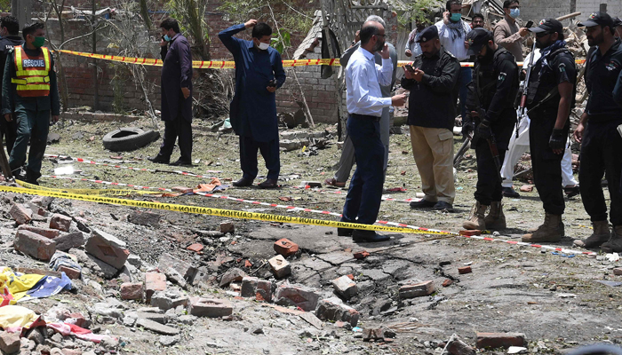 Security officials inspect the site of an explosion that killed at least three people and wounded several others in Lahore on June 23, 2021. — AFP/File