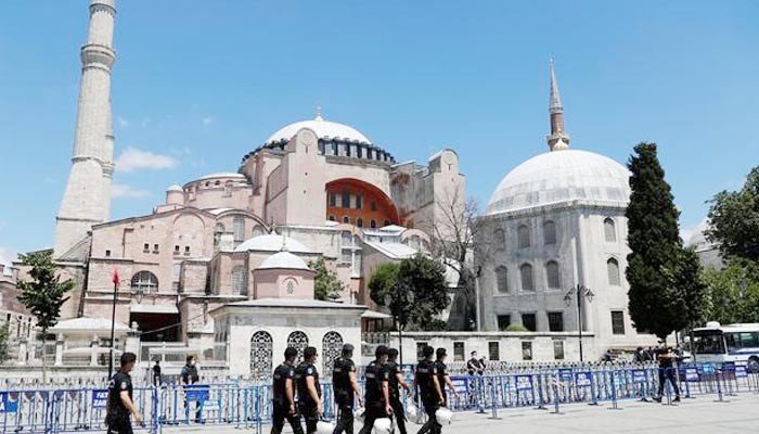 Police officers walk in front of Hagia Sophia, or Ayasofya-i Kebir Camii, in Istanbul, Turkey, July 11, 2020. Photo: Reuters/Files