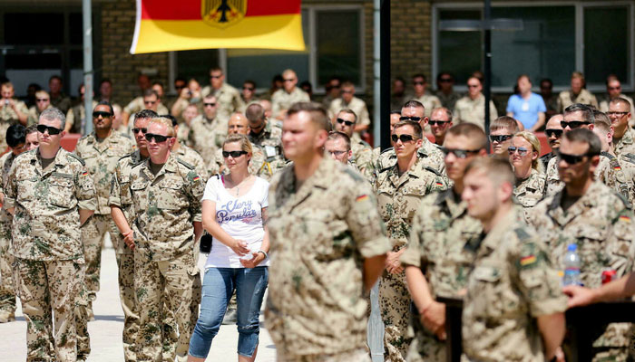 In this file photo taken on May 10, 2013 Soldiers of the German armed forces Bundeswehr listen to a speech of the German Chancellor visiting the Bundeswehr base in Mazar-i-Sharif, Afghanistan. The German Defence Ministry announced on June 29, 2021 the end of the Afghanistan mission and that their soldiers are on their way home. -AFP
