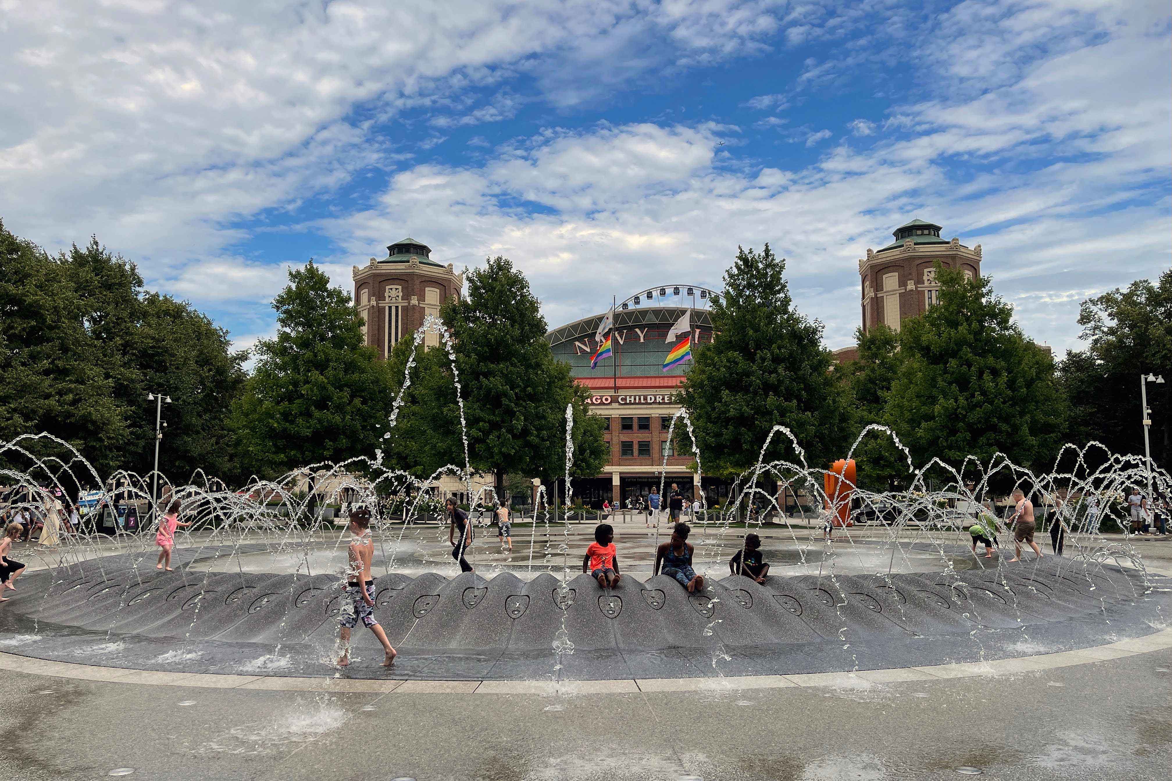 Kids play on a water fountain in downtown Chicago, Illinois as they try to escape the heat on June 29, 2021. — AFP/Daniel Slim