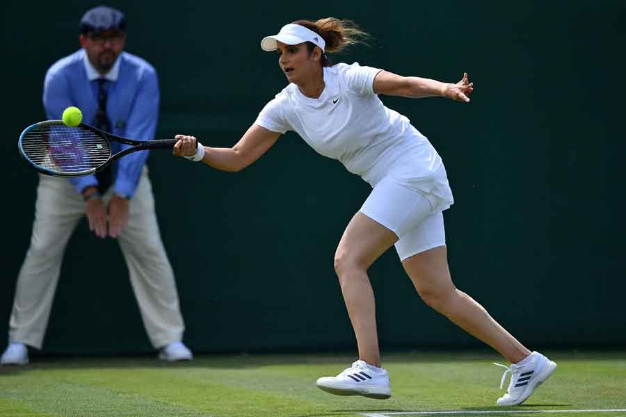 Indias Sania Mirza plays a shot during her womens doubles first round match with on the fourth day of the 2021 Wimbledon Championships at The All England Tennis Club in Wimbledon, southwest London, on July 1, 2021. &mdash; AFP/Ben Stansall