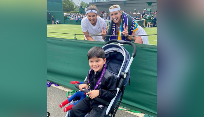 Sania Mirza and her doubles partner Bethanie Mattek-Sands pose with the Indian tennis stars son Izhaan Mirza after winning the Wimbledon’s first round. Photo: Instagram/Sania Mirza