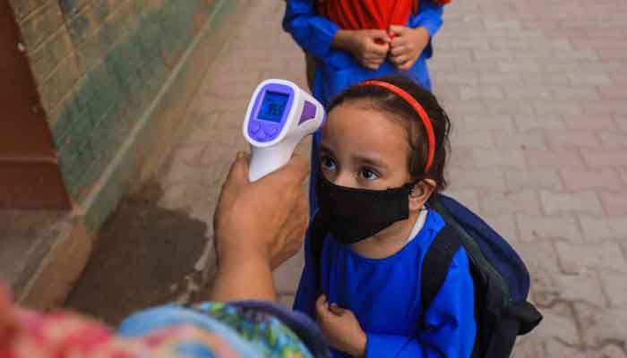 Image of a schoolkid getting her temperature checked through a thermal gun. Photo: File