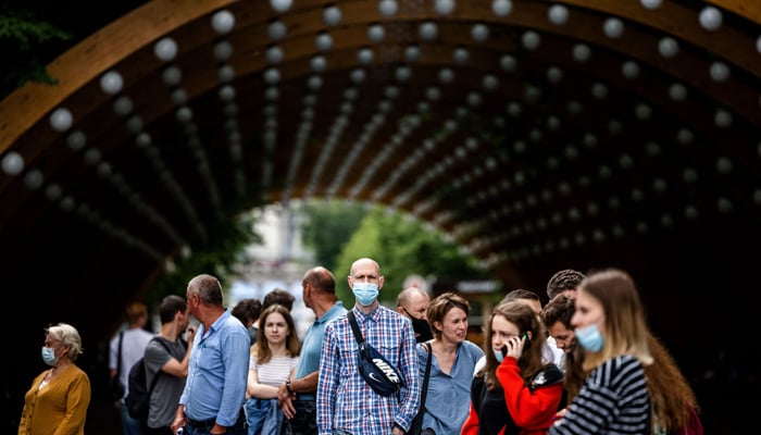 People wait in line to get a COVID-19 vaccine at a vaccination centre in Sokolniki Park in Moscow on July 2, 2021. &mdash; AFP