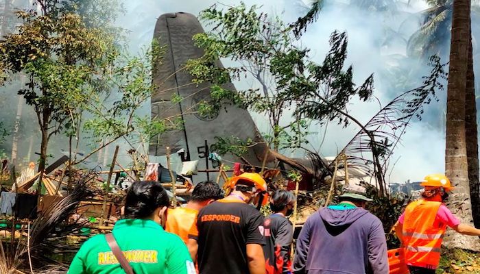 First responders work at the site after a Philippines Air Force Lockheed C-130 plane carrying troops crashed on landing in Patikul, Sulu province, Philippines July 4, 2021. Armed Forces of the Philippines - Joint Task Force Sulu/Handout via REUTERS