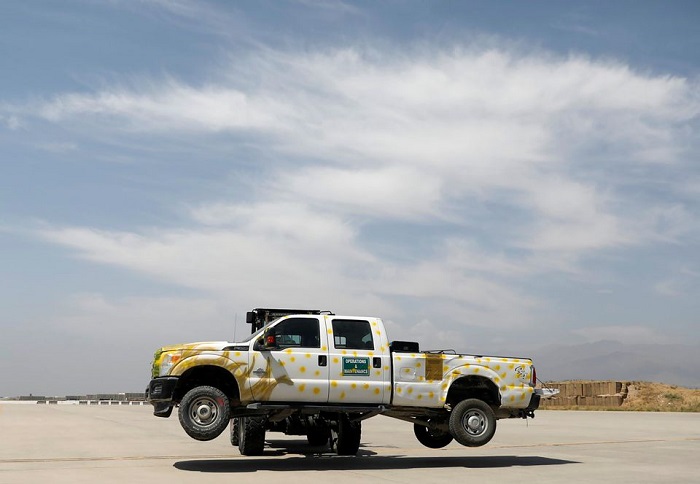 A forklift carries a vehicle in Bagram U.S. air base, after American troops vacated it, in Parwan province, Afghanistan July 5, 2021. Photo: Reuters