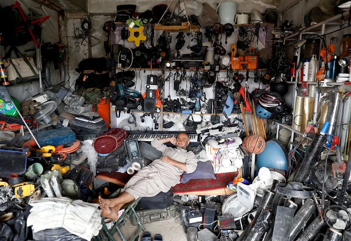 An Afghan man rests in his shop as he sell U.S. second hand materials outside Bagram U.S. air base, after American troops vacated it, in Parwan province, Afghanistan July 5, 2021. Photo: Reuters