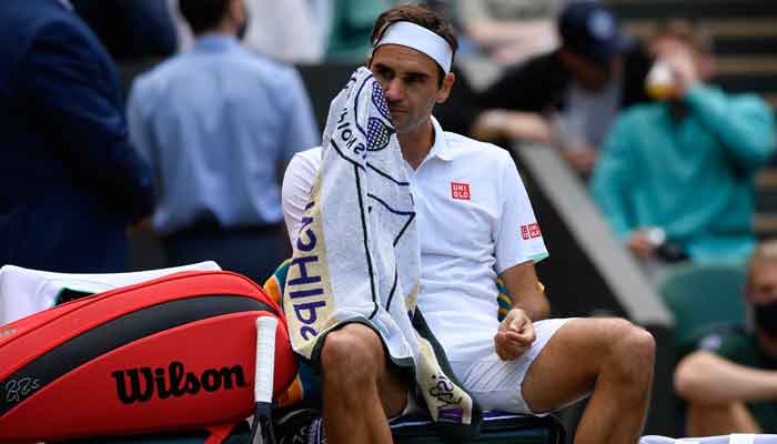 Switzerlands Roger Federer wipes his face during his quarter final match against Polands Hubert Hurkacz at theAll England Lawn Tennis and Croquet Club, London, Britain, July 7, 2021. — Reuters/Toby Melville