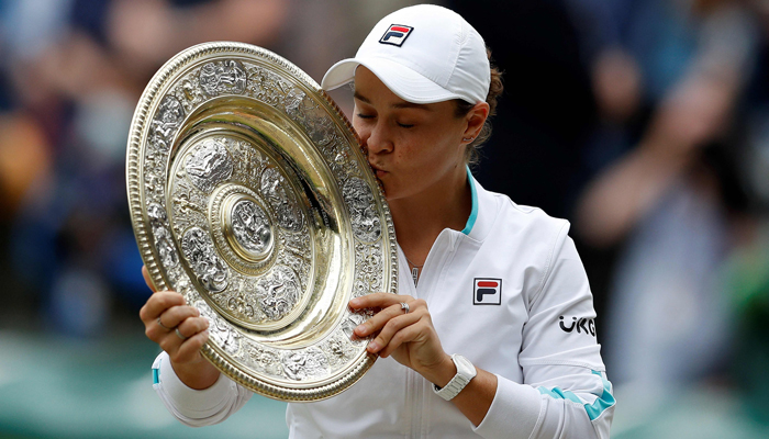 Australias Ashleigh Barty kisses the winners Venus Rosewater Dish trophy after winning her womens singles match against Czech Republics Karolina Pliskova on the twelfth day of the 2021 Wimbledon Championships at The All England Tennis Club in Wimbledon, southwest London, on July 10, 2021. Photo: AFP