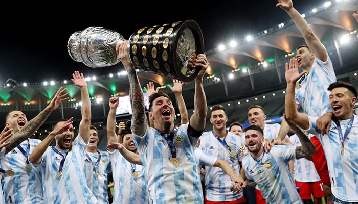 Copa America 2021 - Final - Brazil v Argentina - Estadio Maracana, Rio de Janeiro, Brazil - July 10, 2021 Argentinas Lionel Messi and teammates celebrate winning the Copa America with the trophy. — Reuters