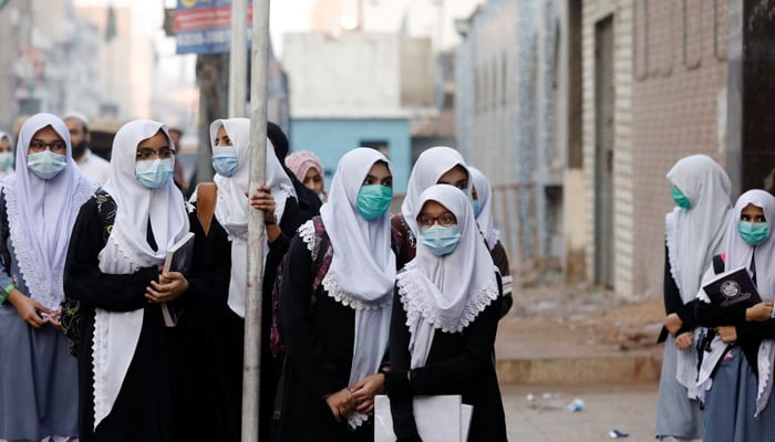 Students gather and wait outside a school building as secondary schools reopen amid the second wave of the coronavirus disease (COVID-19) outbreak, in Karachi, Pakistan January 18, 2021. — Reuters/File