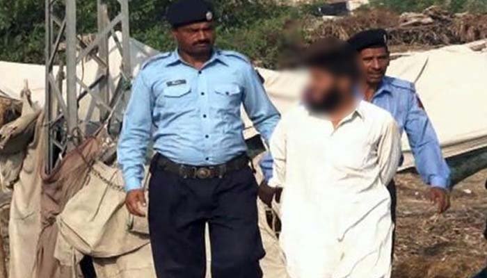 Islamabad Police officers arrest suspect who was roaming outside Parliament House with a gun in one hand and pistol in another. Photo: File