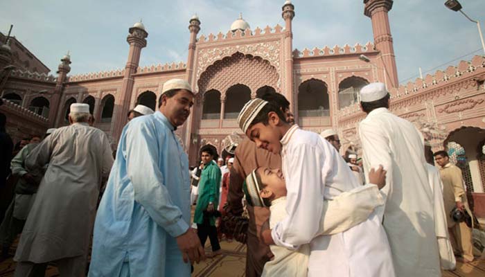 Children hugging each other after Eid prayers in the compound of a mosque. Photo: File