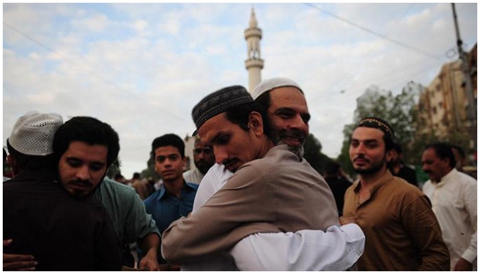 People traditionally embracing each other after Eid prayers to greet each other outside of a mosque. Photo: File