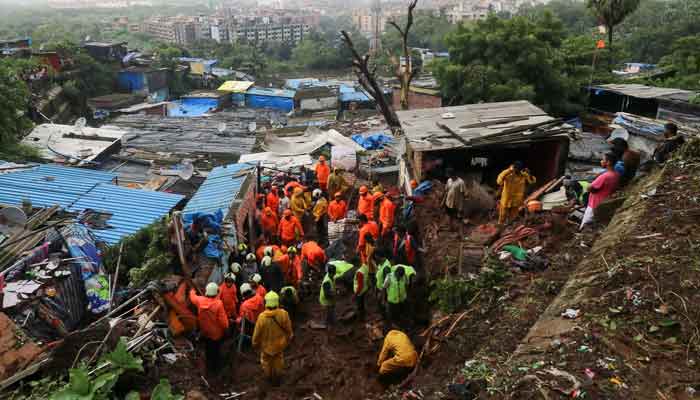Rescue workers search for survivors after a residential house collapsed due to landslide caused by heavy rainfall in Mumbai, India, July 18, 2021. — Reuters/Niharika Kulkarni