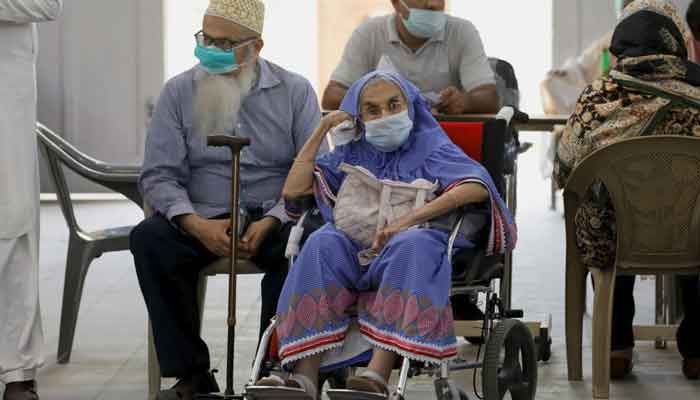 Residents wait for their coronavirus disease (COVID-19) vaccine doses, at a vaccination center in Karachi, Pakistan, April 2, 2021. — Reuters/Akhtar Soomro