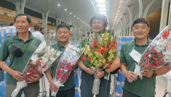 South Korean climber Kim Hong-Bin (2nd R) along with team members hold bouquets at the airport in Islamabad, Pakistan, June 16, 2021.— Karrar Haidri/Alpine Club of Pakistan/Handout via Reuters