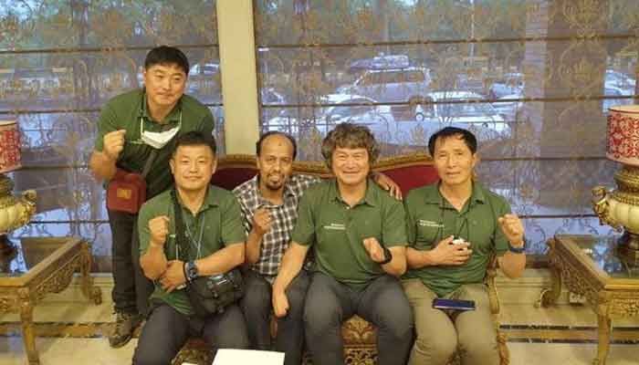 South Korean climber Kim Hong-Bin (2nd R) and his team pose with a member of Alpine Club of Pakistan at the airport in Islamabad, Pakistan, June 16, 2021. — Karrar Haidri/Alpine Club of Pakistan/Handout via Reuters