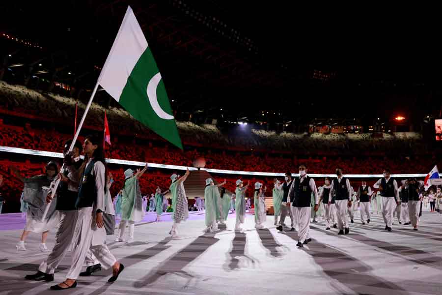 Pakistans flag bearers Muhammad Khalil Akhtar (L) and Mahoor Shahzad (2L) lead their delegation as they parade during the opening ceremony of the Tokyo 2020 Olympic Games, at the Olympic Stadium, in Tokyo, on July 23, 2021. — Photo by Odd Andersen/AFP)