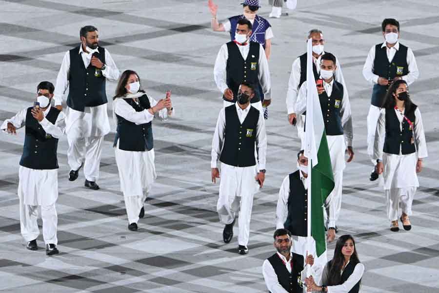 Pakistans flag bearer Mahoor Shahzad and Pakistans flag bearer Muhammad Khalil Akhtar lead the delegation during the opening ceremony of the Tokyo 2020 Olympic Games, at the Olympic Stadium, in Tokyo, on July 23, 2021. — Photo by Martin Bureau/AFP
