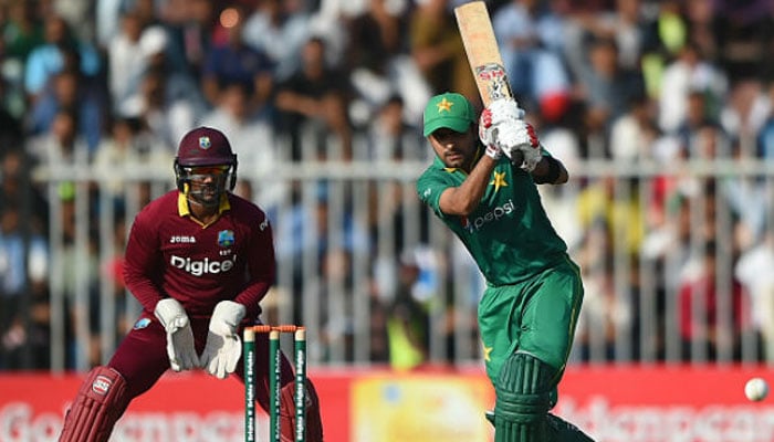 A Pakistani batsman playing a shot while West Indian wicketkeeper