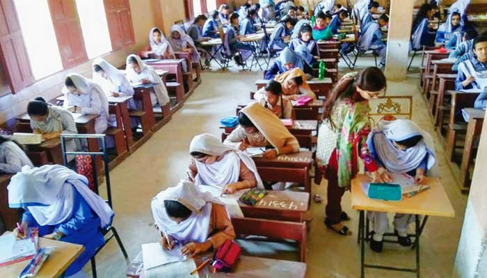 Students can be seen attempting their exams in the examination centre. — File photo