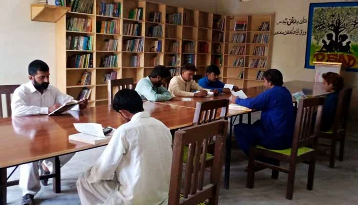 Students can be seen reading at a library established by social activists in Sindhs Karoondi Town. — Photo by authors