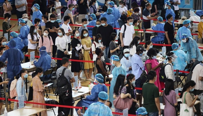 People line up for nucleic acid testing at a sports centre in Gulou district, during a citywide mass testing following new cases of the coronavirus disease (COVID-19) in Nanjing, Jiangsu province, China July 22, 2021. Photo: cnsphoto via Reuters