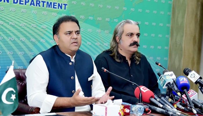 Federal Minister for Information and Broadcasting Fawad Chaudhry (left) addressing a press conference alongside Federal Minister for Kashmir Affairs and Gilgit-Baltistan Ali Amin Gandapur (right) in at PID Islamabad, on July 26, 2021. — PID