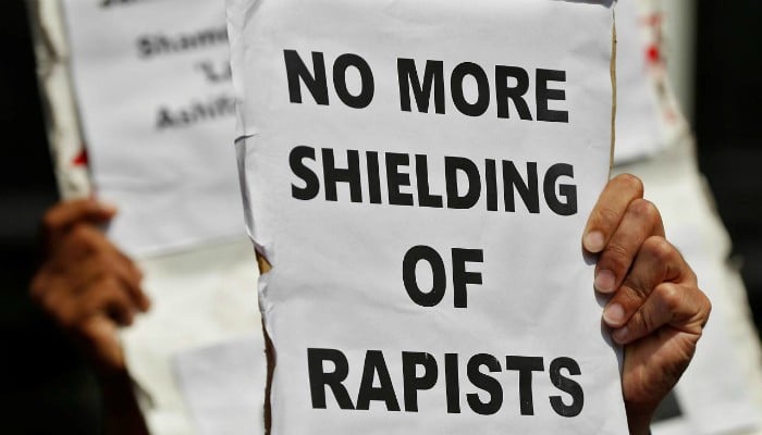 People hold placards at a protest against the rape of an eight-year-old girl, in Kathua, near Occupied  Jammu and Kashmir in New Delhi, India April 12, 2018. — Reuters/File