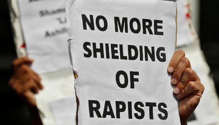 People hold placards at a protest against the rape of an eight-year-old girl, in Kathua, near Occupied Jammu and Kashmir in New Delhi, India April 12, 2018. — Reuters/File