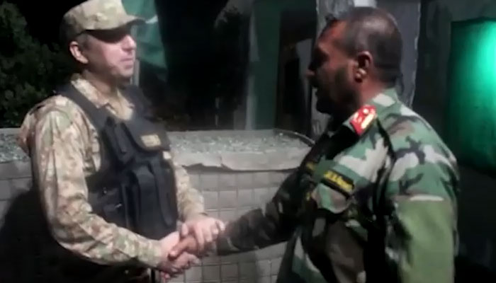 Pakistan Army officer meeting ANA commander during handover ceremony.