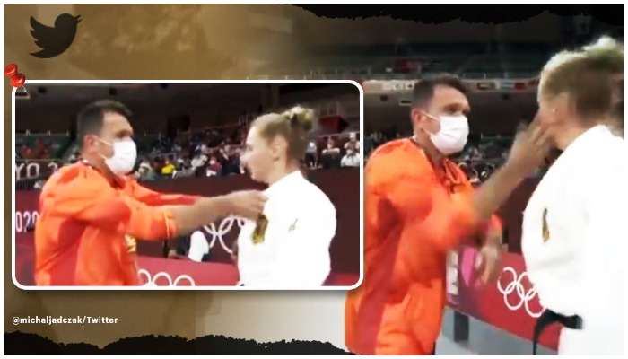 Judoka Martyna Trajdos receives a couple of slaps from the coach. Screenshot from video tweeted by michaljadczak