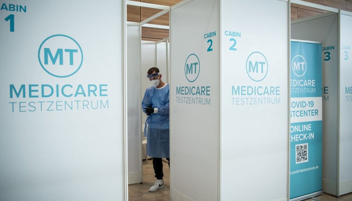 A medical staff waits for passengers to take a coronavirus (Covid-19) test at a test center at Berlin Brandenburg Airport Willy Brandt (BER) in Schoenefeld southeast of Berlin on July 28, 2021. — AFP/File