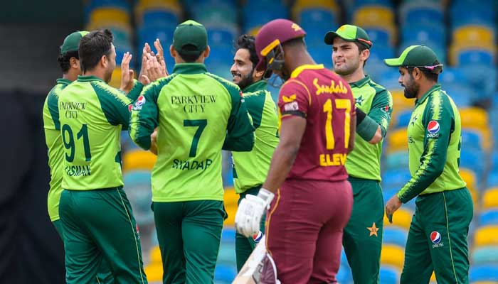 Hasan Ali (3rdL), Shareen Afridi (2ndR) and Shadab Khan (R) of Pakistan celebrate the dismissal of Evin Lewis (4thL) of West Indies during the 1st T20I between West Indies and Pakistan at Kensington Oval, Bridgetown, Barbados, on July 28, 2021.-AFP