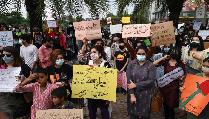 Citizens hold placards during a demonstration in Lahore on July 24, 2021, against the brutal killing of Noor Mukadam, the daughter of former Pakistan envoy to South Korea, in the federal capital earlier this week. — AFP