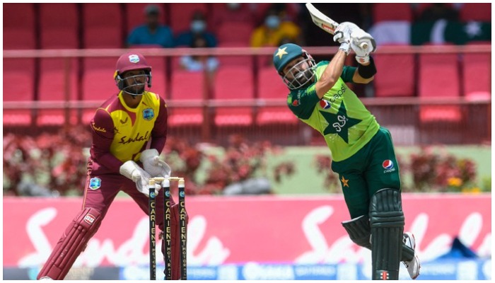 Mohammad Rizwan (R) of Pakistan hits 6 and Nicholas Pooran (L) of the West Indies looks on during the 3rd T20I match between the West Indies and Pakistan at Guyana National Stadium in Providence, Guyana, on July 31, 2021. —AFP