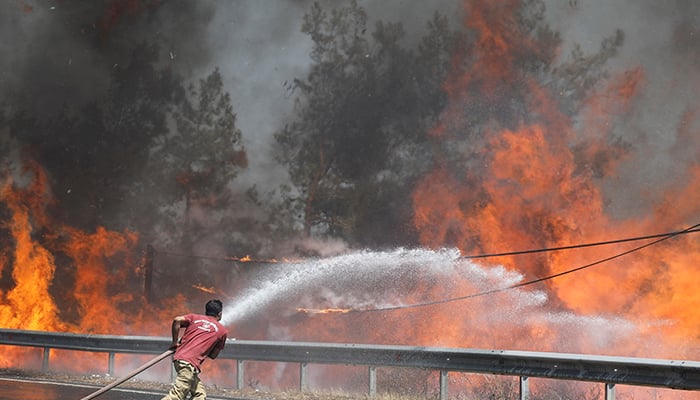 A firefighter tries to extinguish a wildfire near Marmaris, Turkey, August 1, 2021. — Reuters