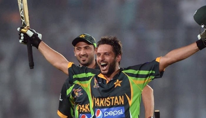 Shahid Afridi celebrates with Junaid Khan after hitting the ball over the fence for a six against India. Photo: AFP