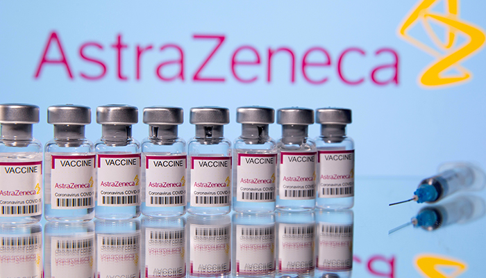 Vials labelled Astra Zeneca COVID-19 Coronavirus Vaccine and a syringe are seen in front of a displayed AstraZeneca logo, in this illustration photo taken March 14, 2021. — Reuters/File