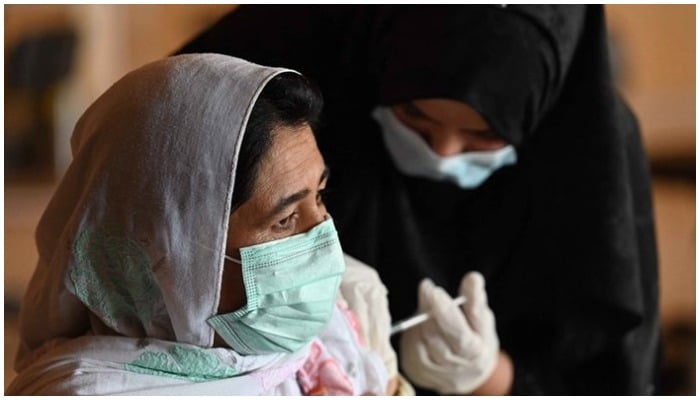 Picture showing a woman wearing a mask getting the COVID-19 jab. Photo: AFP/File.