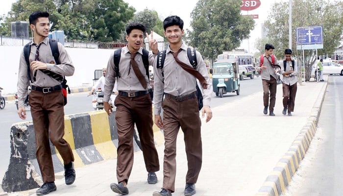 Students of a secondary educational institution can be seen outside school premises in Karachi, on June 15, 2021. — PPI/File