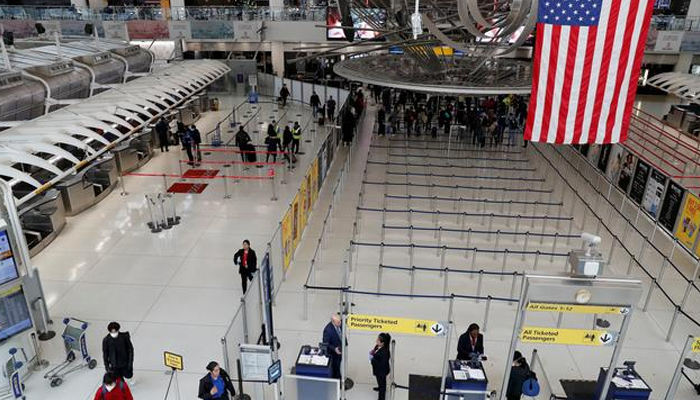Passengers walk through Terminal 1, after further cases of coronavirus were confirmed in New York, at JFK International Airport in New York, US, on March 13, 2020. — Reuters/File