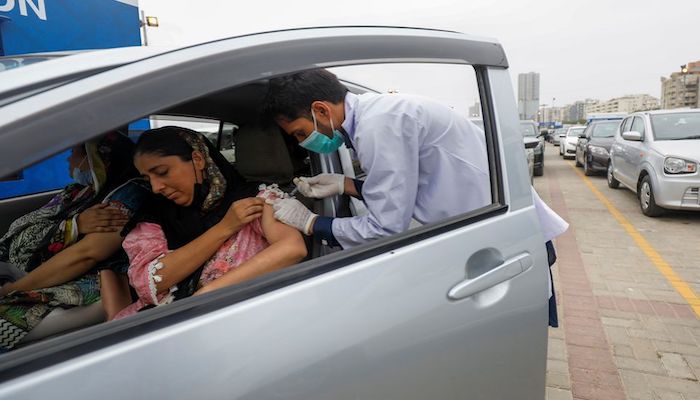 A resident receives a vaccine against coronavirus disease (COVID-19) at the drive-through vaccination facility in Karachi, Pakistan July 29, 2021