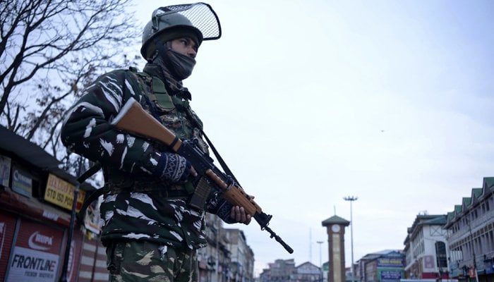 An Indian trooper stands guard at a roadblock during a one-day strike called by Kashmiris as they observe Indias Republic Day as Black Day. Photo: AFP